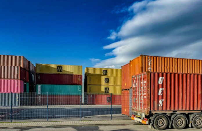 Photo by Bernd 📷 Dittrich a truck is parked in front of a bunch of shipping containers