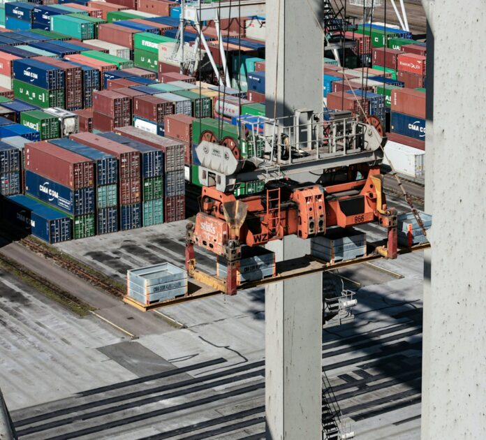 Photo by Bernd 📷 Dittrich an overhead view of cargo containers and a crane